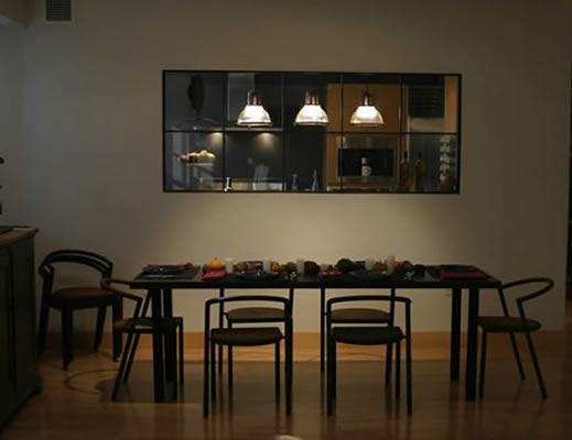 Weathered dining table and iron window partition